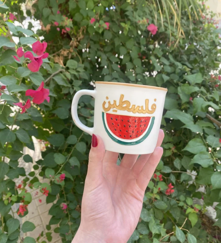 Glass mug with a unique design featuring the word "Palestine